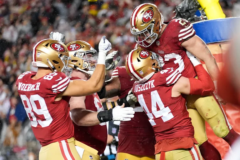 San Francisco 49ers running back Christian McCaffrey (23) celebrates his rushing touchdown with teammates during the second half of an NFL football NFC divisional playoff game against the Green Bay Packers Saturday, Jan. 20, 2024, in... (AP Photo/Ashley Landis)