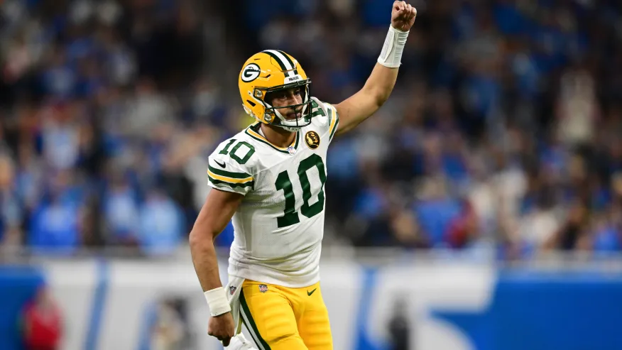 Green Bay Packers quarterback Jordan Love runs up field after throwing a touchdown to wide receiver Christian Watson during the second half of an NFL football game against the Detroit Lions, Thursday, Nov. 23, 2023, in Detroit. (AP Photo/David Dermer)